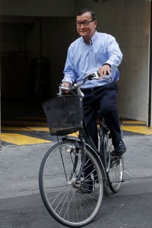 Former president of the dissolved opposition Cambodia National Rescue Party (CNRP) Sam Rainsy, who is living in exile, poses on his bicycle in Paris, France, July 19, 2018. REUTERS/Philippe Wojazer