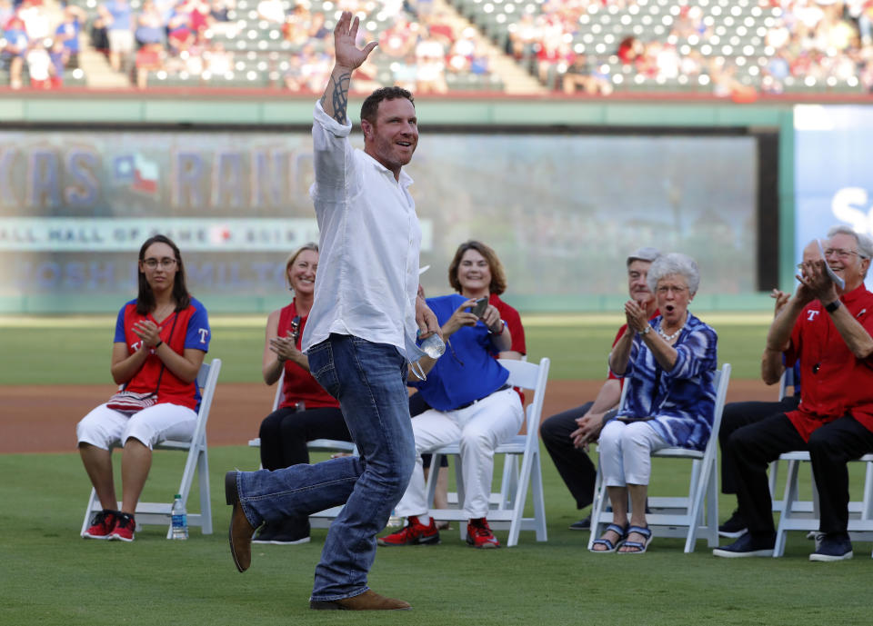 Former Texas Rangers player Josh Hamilton jogs onto the field for club Hall of Game ceremony where Hamilton and former Arlington Mayor Richard Greene were honored, before the team's baseball game against the Minnesota Twins in Arlington, Texas, Saturday, Aug. 17, 2019. (AP Photo/Tony Gutierrez)