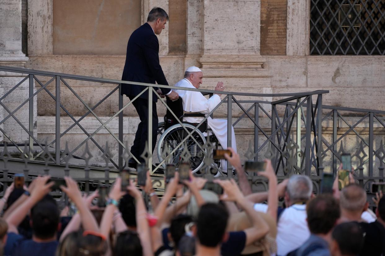 Pope Francis uses a wheelchair as he greets the faithful as he leaves St. Mary Major Basilica after participating in a rosary prayer for peace in Rome on May 31, 2022. 