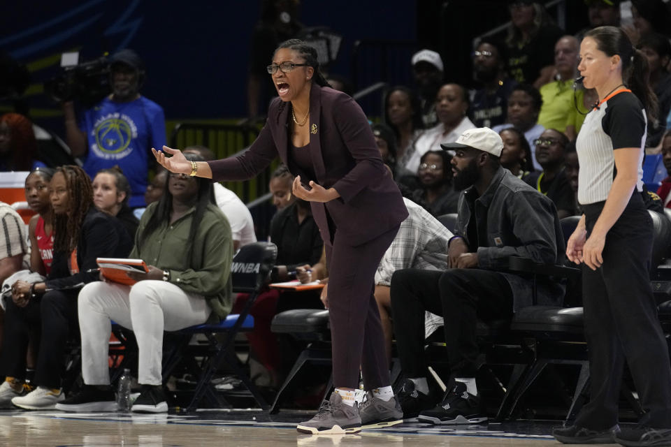 Atlanta Dream head coach Tanisha Wright, center, instructs her team in the first half of Game 2 of a first-round WNBA basketball playoff series against the Dallas Wings, Tuesday, Sept. 19, 2023, in Arlington, Texas. (AP Photo/Tony Gutierrez)