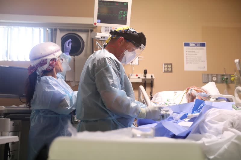 Pulmonary and critical care physician Dr. Robert Goldberg, 44, puts an arterial line for blood pressure monitoring in a coronavirus disease (COVID-19) patient in the ICU at Providence Mission Hospital in Mission Viejo