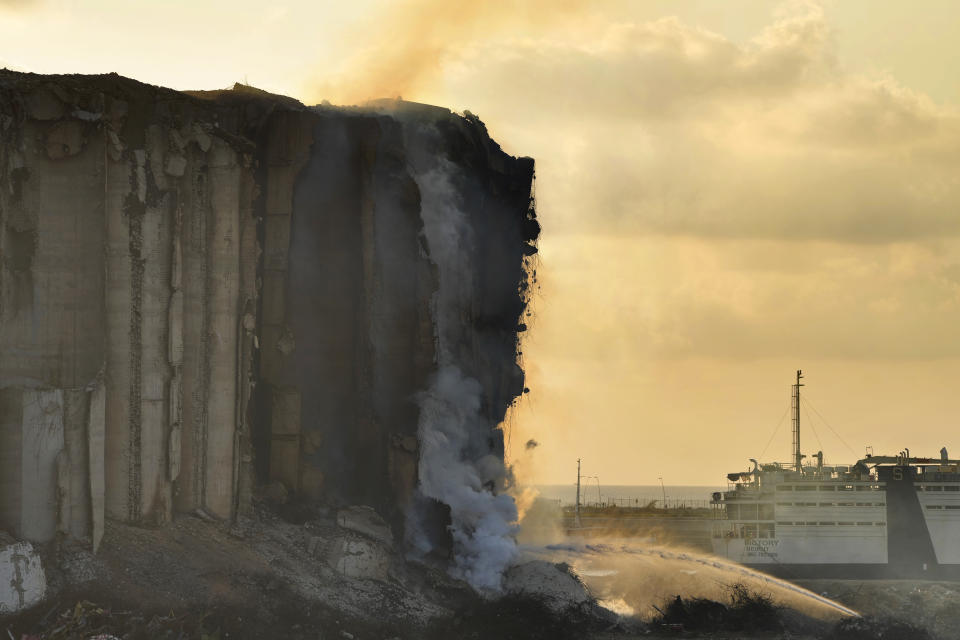 Firefighters extinguish a fire at the silos in the north block of the Beirut Port in Beirut, Lebanon, Thursday, July 21, 2022. The silos were destroyed by a massive explosion in 2020 and the structure might have caught on fire due to fermented grains.(AP Photo/Hassan Ammar)