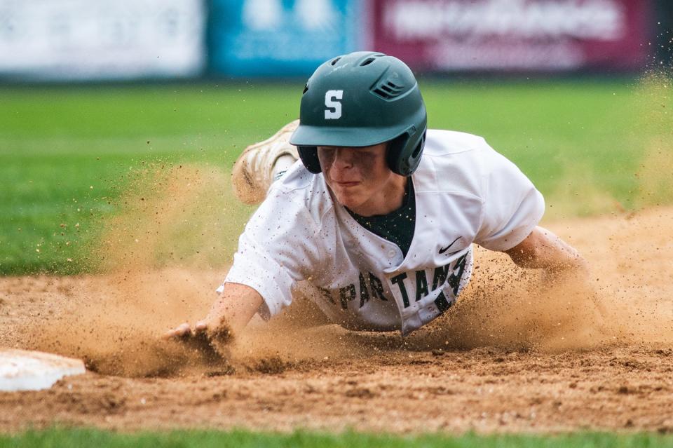 Spackenkill's Dylan Updike slides into first base during the Class B sub regional baseball game at Cantine Field in Saugerties, NY on Thursday, June 2, 2022. Spackenkill defeated Rye Neck 8-5. KELLY MARSH/FOR THE TIMES HERALD-RECORD