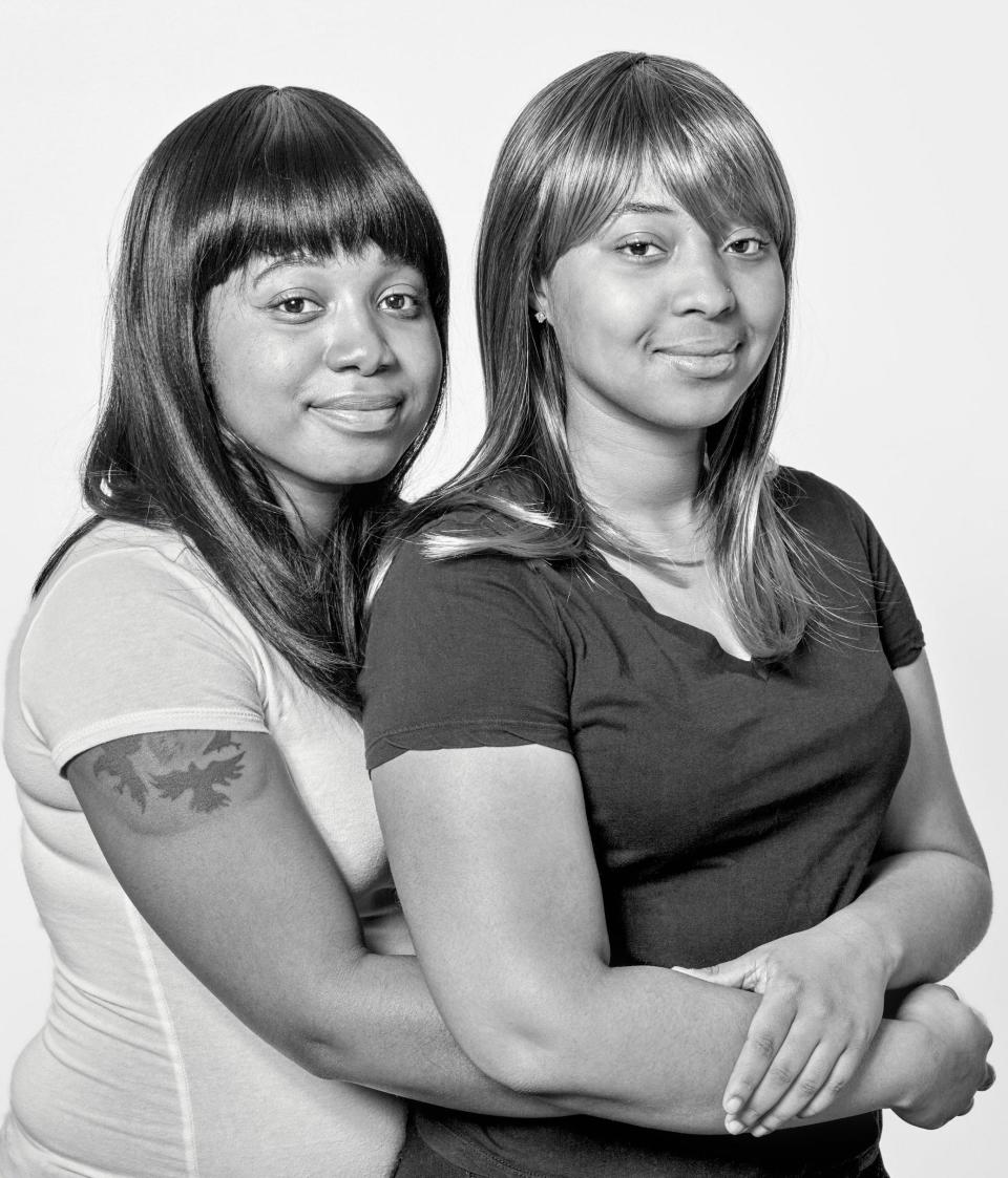 two look alike women, smiling, holding each other