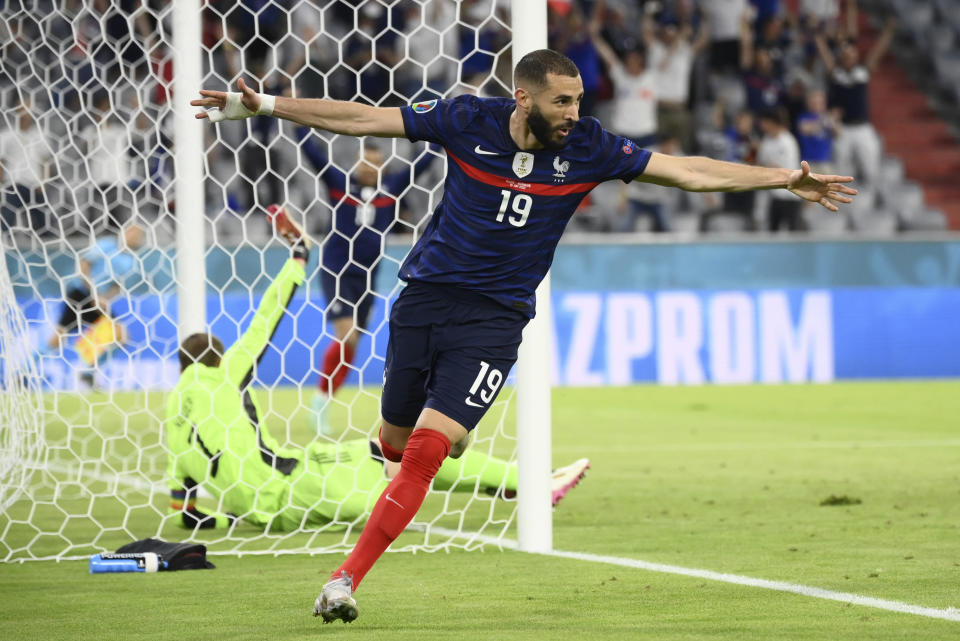 France's Karim Benzema runs to celebrate scoring a goal that was overturned for an offside during the Euro 2020 soccer championship group F match between Germany and France at the Allianz Arena stadium in Munich, Tuesday, June 15, 2021. (Franck Fife/Pool via AP)