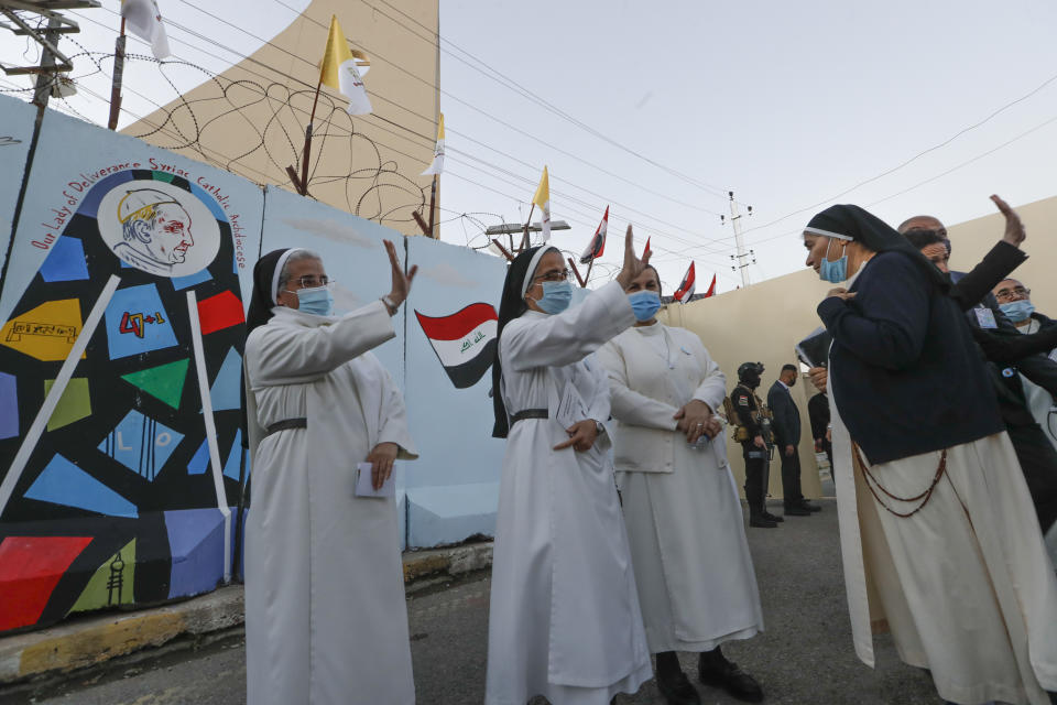 Nuns waves as Pope Francis leaves the Sayidat al-Nejat (Our Lady of Salvation) Cathedral, in Baghdad, Iraq, Friday, March 5, 2021. Pope Francis has arrived in Iraq to urge the country's dwindling number of Christians to stay put and help rebuild the country after years of war and persecution, brushing aside the coronavirus pandemic and security concerns. (AP Photo/Andrew Medichini)