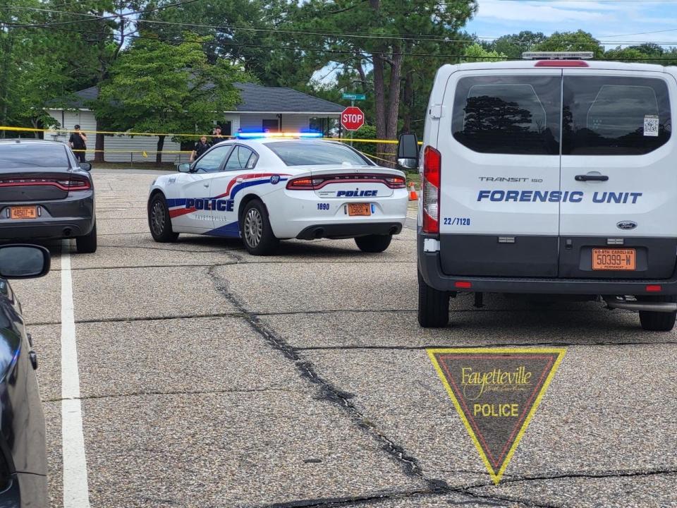 Police vehicles are parked near the area on Stanberry Street where Lorenzo McLaughlin was fatally wounded July 29, 2023.