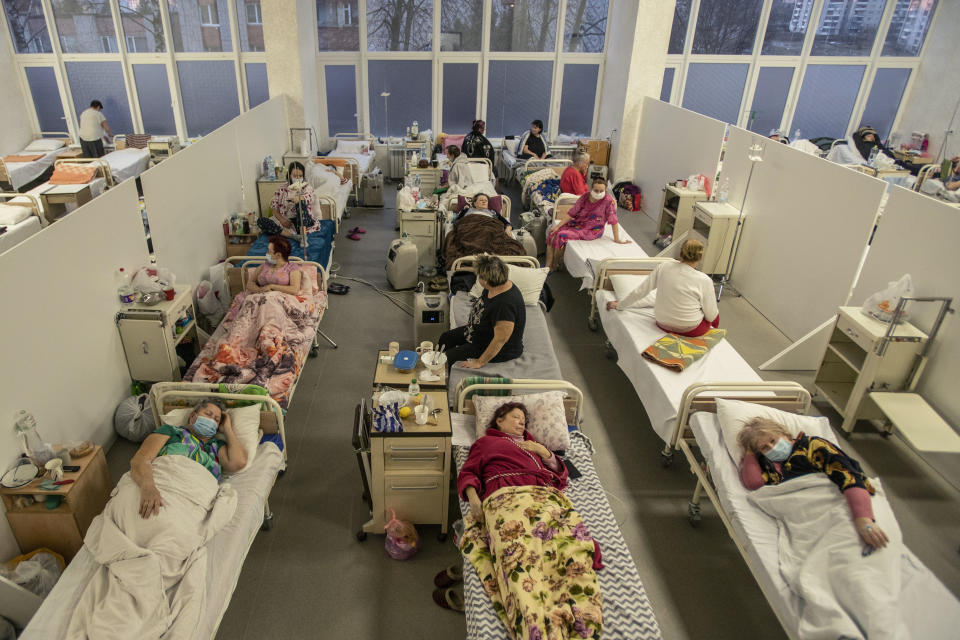 Patients with COVID-19 are seen in a hospital in Lviv, western Ukraine, Tuesday, March 23, 2021. Ukraine, which is struggling with a third wave of rising coronavirus infections, has recorded its highest daily death toll from COVID-19. (AP Photo/Evgeniy Maloletka)
