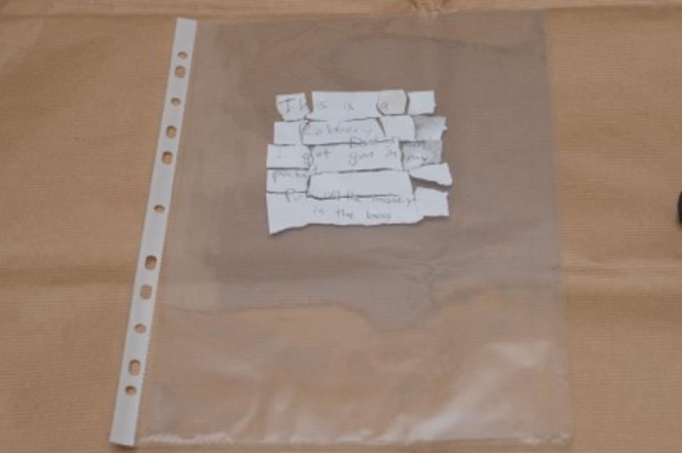 The torn written note used by Mahadi Muhamad Mukhtar in his armed robbery. (PHOTO: Singapore Police Force)