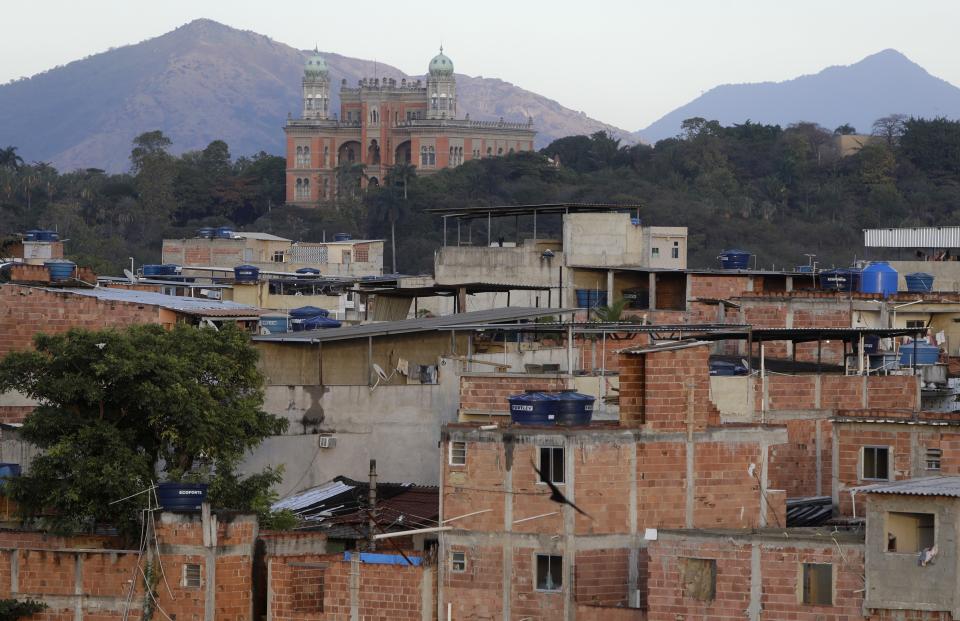 Homes stand in the Complexo da Mare, where the Fiocruz foundation is located, behind, top left, on the first day of a three-day COVID-19 vaccination campaign for people over age 35 in this favela of Rio de Janeiro, Brazil, Thursday, July 29, 2021. Some recipients will be monitored to study the rate of protection the vaccines provide and the extent to which virus variants are circulating. (AP Photo/Bruna Prado)