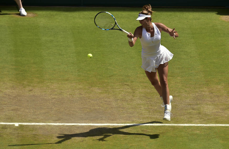 Garbine Muguruza of Spain returns the ball to Serena Williams of the United States during the women's singles final at the All England Lawn Tennis Championships in Wimbledon, London, Saturday July 11, 2015. (Dominic Lipinski/Pool Photo via AP)