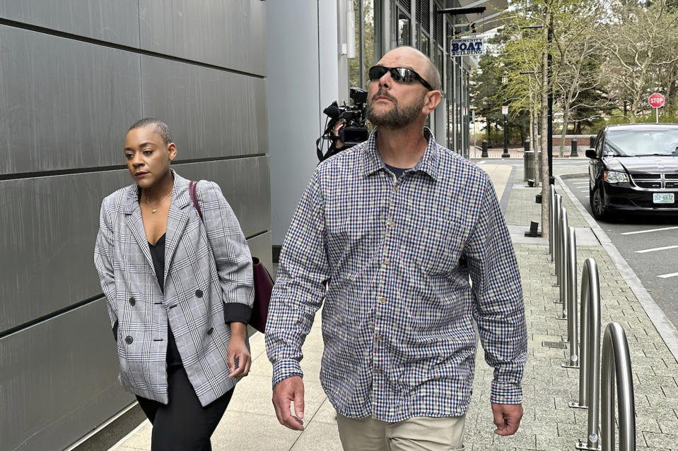 A member of Jack Teixeira's family, right, leaves the Moakley Federal Courthouse, Wednesday, April 19, 2023, in Boston. Teixeira, the Massachusetts Air National Guardsman charged with leaking highly classified military documents, made a brief court appearance Wednesday, as a hearing to determine whether he should remain jailed while awaiting trial was delayed to give the defense more time to prepare. (AP Photo/Michael Casey)