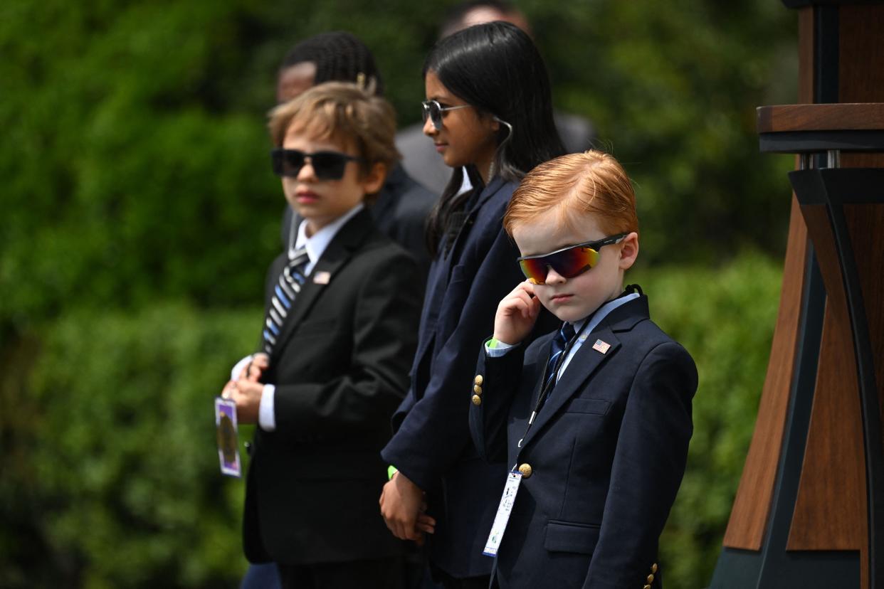 Children take the place of U.S. Secret Service agents as President Joe Biden speaks during a Take Your Child to Work Day welcome on the South Lawn of the White House on April 27, 2023, in Washington, D.C.