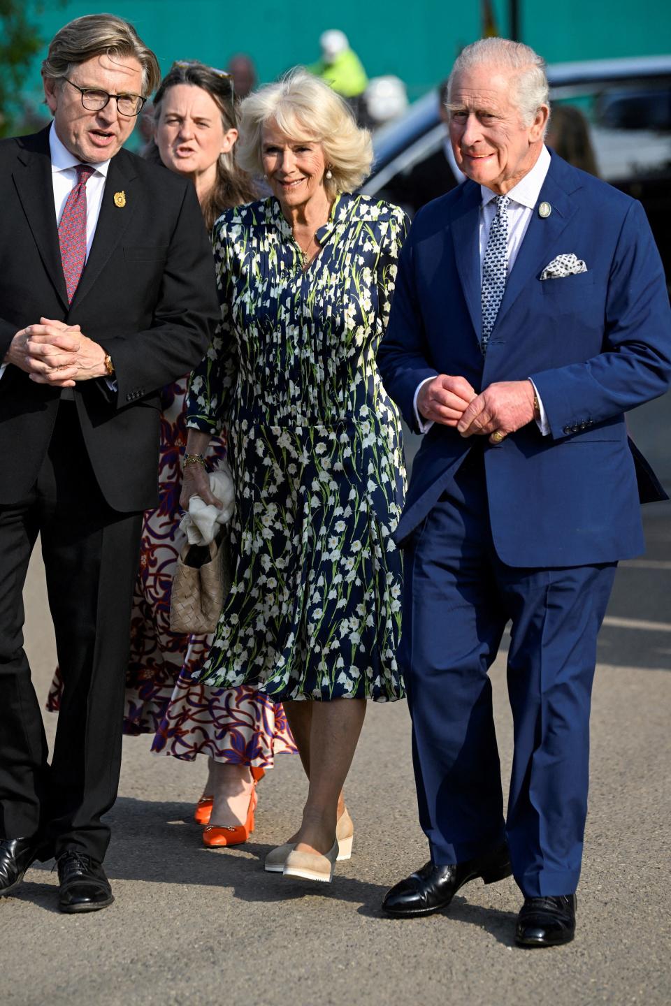 Britain's King Charles III (R) and Britain's Queen Camilla (L) arrive with President of Royal Horticultural Society (RHS) Keith Weed, for a visit to the 2023 RHS Chelsea Flower Show in London on May 22, 2023. The Chelsea flower show is held annually in the grounds of the Royal Hospital Chelsea. (Photo by TOBY MELVILLE / POOL / AFP) (Photo by TOBY MELVILLE/POOL/AFP via Getty Images)