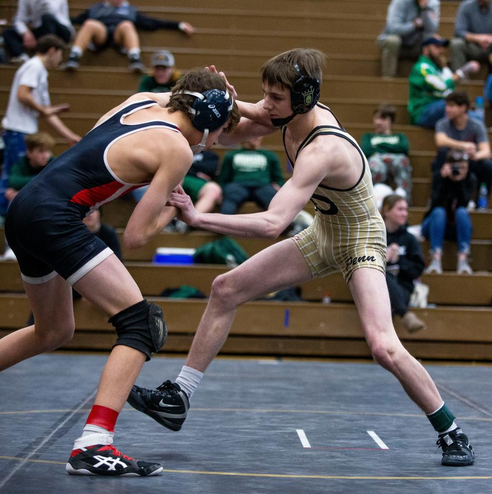 Penn's Dylan Bennett and Plymouth's Braxton White compete in the 113-pound championship match of the regional wrestling meet Saturday, Feb. 5, 2022 at Penn High School. 
