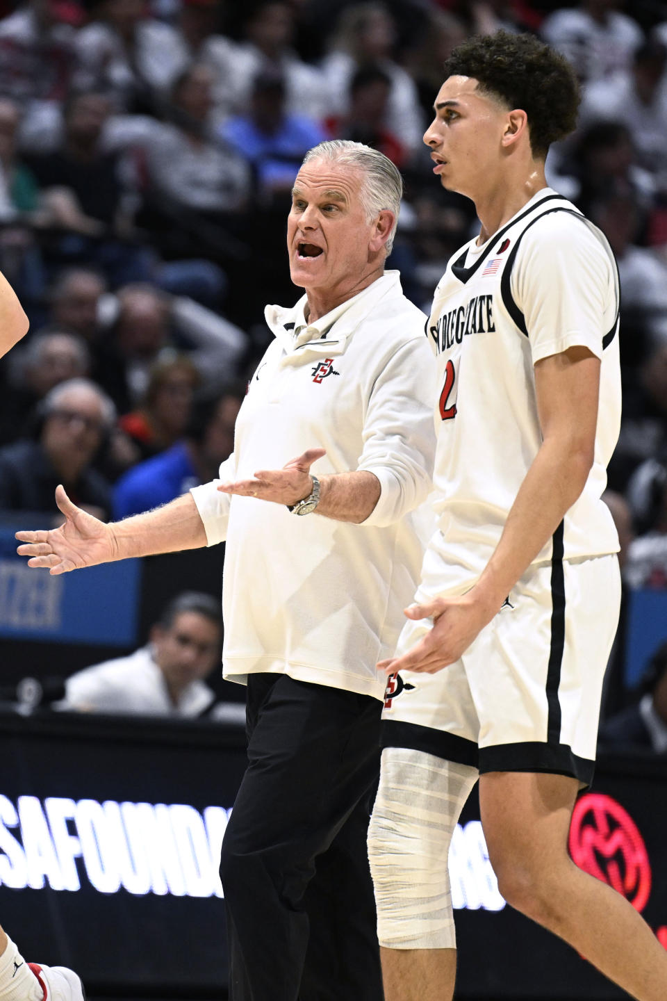 San Diego State coach Brian Dutcher talks with guard Miles Byrd during the second half of the team's NCAA college basketball game against Boise State on Friday, March 8, 2024, in San Diego. (AP Photo/Denis Poroy)