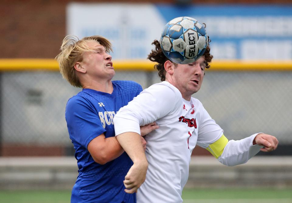 Penfield's Shane McMillan steps in front of Schroeder's Rory Carney.