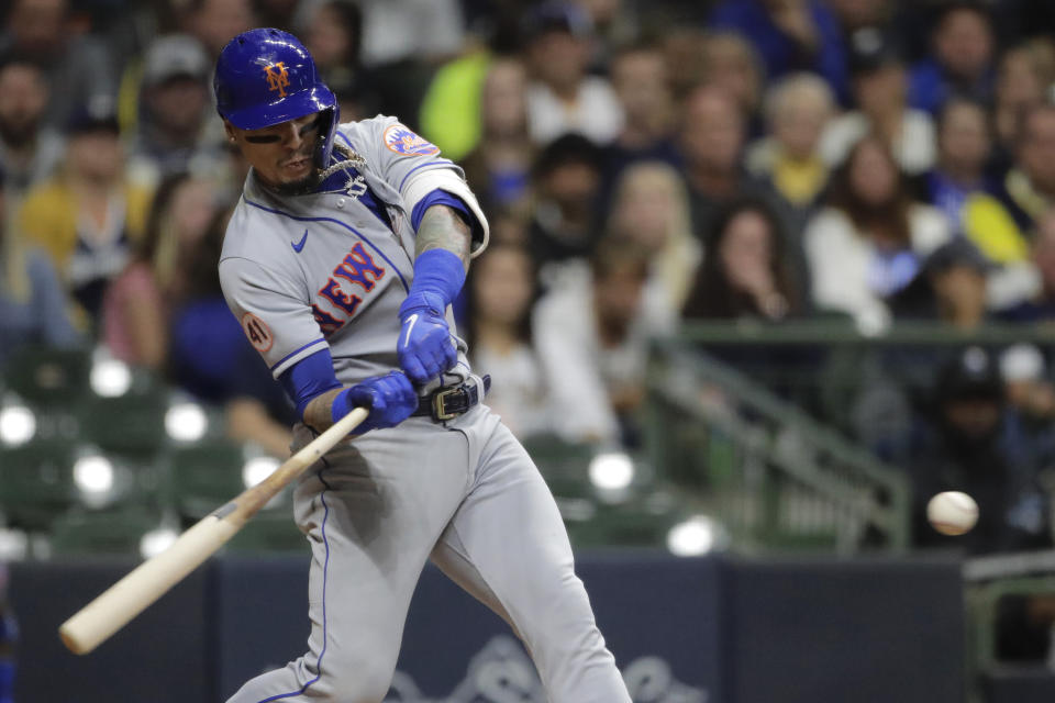 New York Mets' Javier Baez hits an RBI-single during the fourth inning of a baseball game against the Milwaukee Brewers, Saturday, Sept. 25, 2021, in Milwaukee. (AP Photo/Aaron Gash)