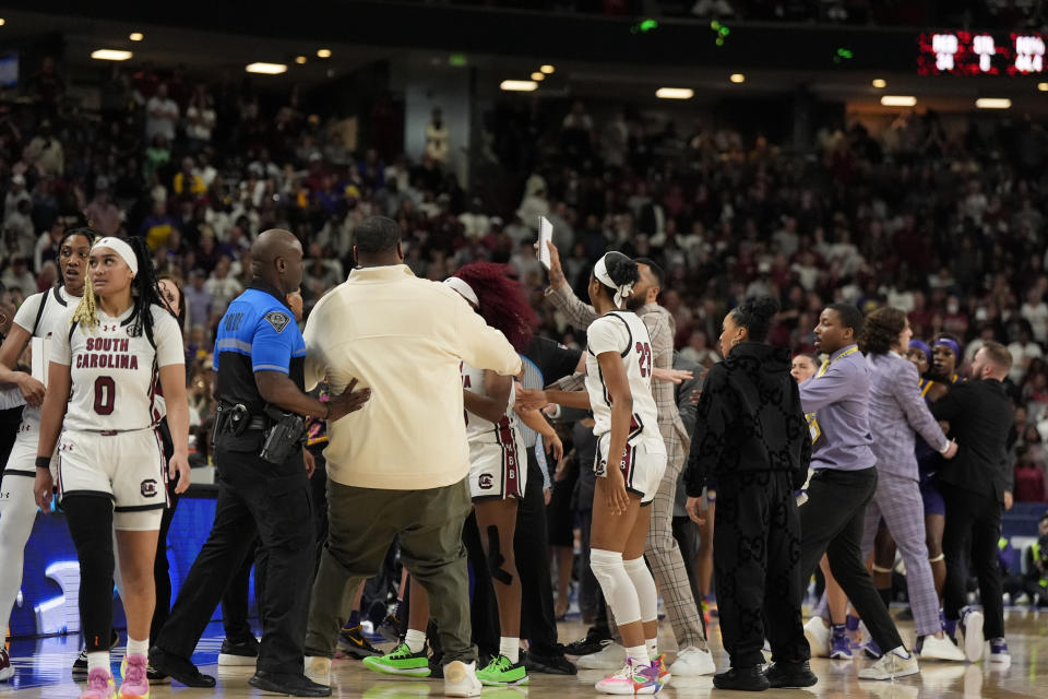 The benches clear during a player altercation during the second half of an NCAA college basketball game against LSU at the Southeastern Conference women's tournament final Sunday, March 10, 2024, in Greenville, S.C. (AP Photo/Chris Carlson)