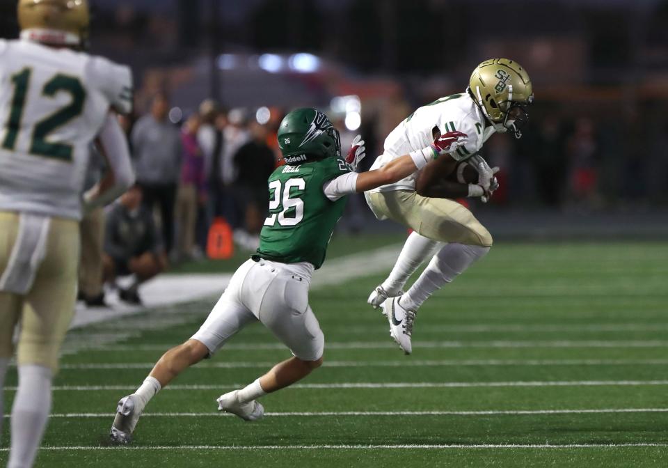 St. Bonaventure's DJ Doss makes a leaping catch in front of Pacifica's Vernon Bell during the second quarter of the teams' nonleague showdown at Pacifica High on Friday, Aug. 25, 2023. Pacifica won 24-13.