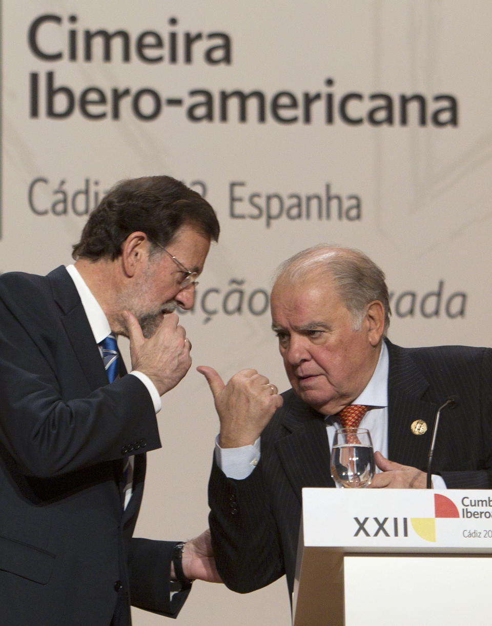 Spain's Prime Minister Mariano Rajoy, left, and Iberoamerican Secretary General Enrique Iglesias, right, talk during a press conference at the XXII Iberoamerican summit in the southern Spanish city of Cadiz, Saturday, Nov. 17, 2012. In an historic role reversal, recession-hit Spain and Portugal on Friday courted the Latin American leaders of their former colonies, countries that now enjoy some of the strongest economic growth in the world. Spain's King Juan Carlos opened the annual Iberoamerican summit, which brings together the heads of Spain and Portugal and the leaders of Latin America to discuss political issues and arrange business deals. (AP Photo/Miguel Angel Morenatti)