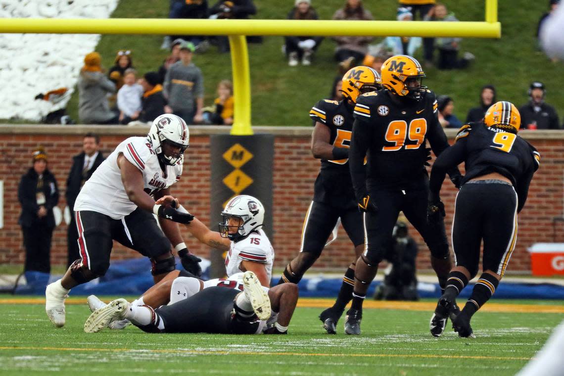 Offensive lineman Tyshawn Wannamaker helps quarterback Jason Brown off the turf as South Carolina takes on Missouri in a college football game on Saturday, Nov. 13, 2021 at Faurot Field in Columbia, Missouri.