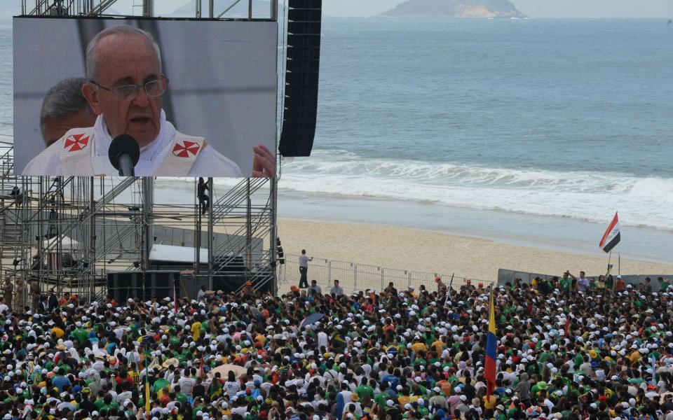 Hundreds of thousands of people crowded Copacabana beach in Rio de Janeiro in 2013 as Pope Francis celebrated the final mass of his visit to Brazil - AFP