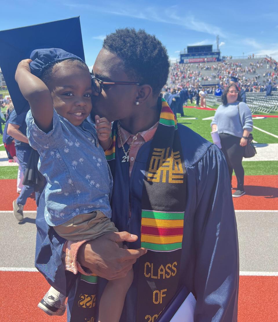 Khalid Dorsey holds his son, Kiyan, after graduating from Shippensburg University this spring. Dorsey will take graduate classes at Slippery Rock University this upcoming school year.