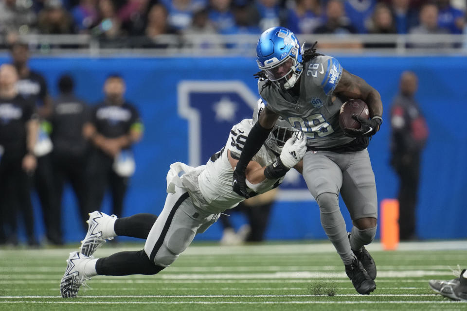 Las Vegas Raiders linebacker Luke Masterson (59) stops Detroit Lions running back Jahmyr Gibbs (26) during the first half of an NFL football game, Monday, Oct. 30, 2023, in Detroit. (AP Photo/Paul Sancya)