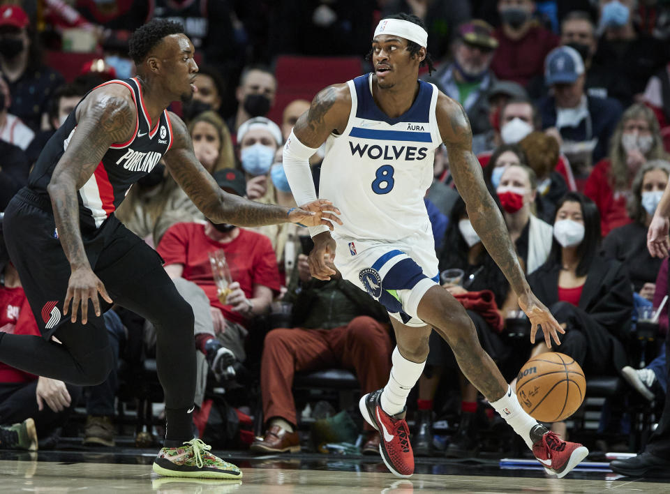 Minnesota Timberwolves forward Jarred Vanderbilt, right, dribbles around Portland Trail Blazers forward Nassir Little during the first half of an NBA basketball game in Portland, Ore., Tuesday, Jan. 25, 2022. (AP Photo/Craig Mitchelldyer)