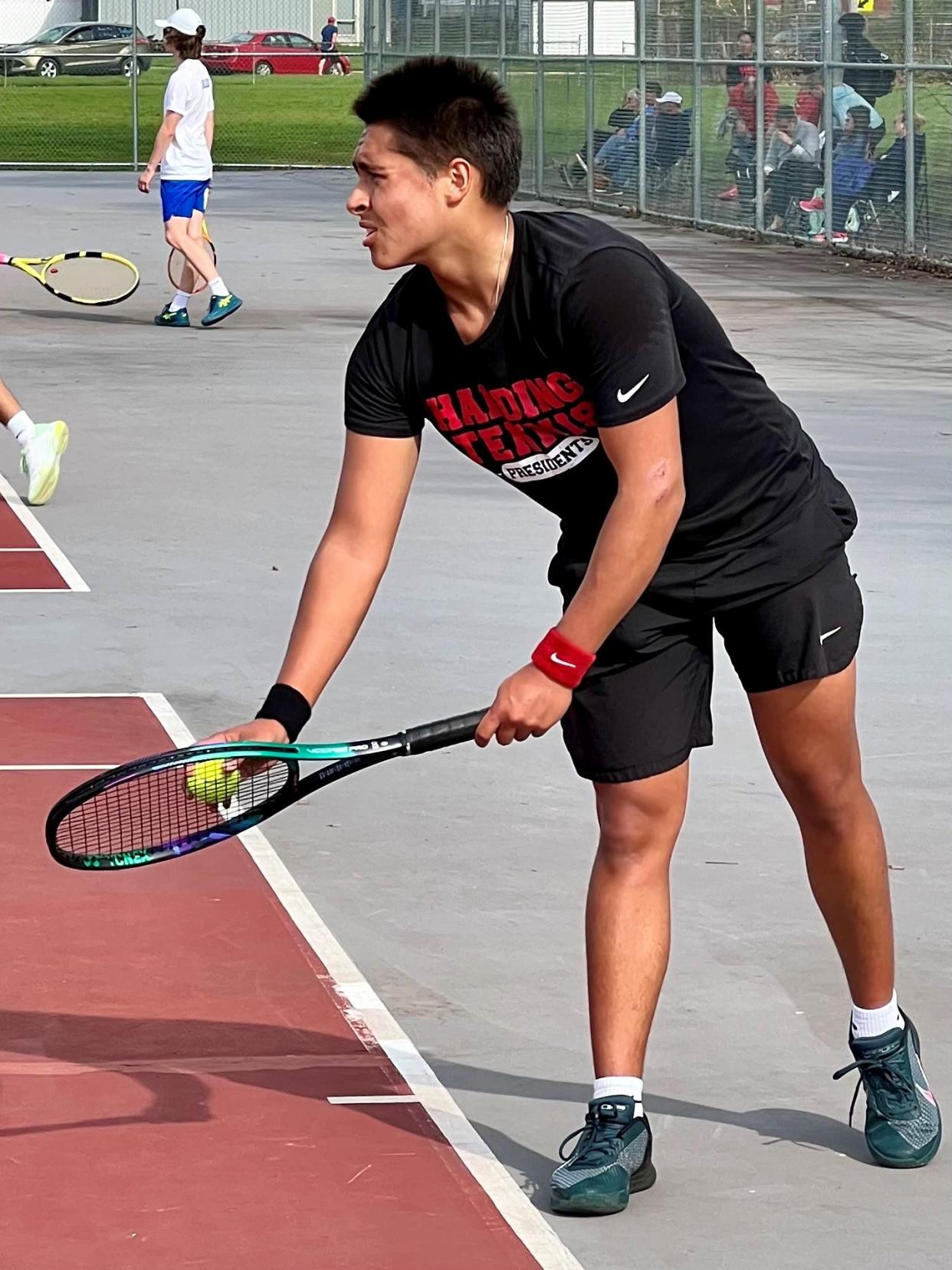 Marion Harding's first singles tennis player Alexander Lisiecki gets set to serve during a home match earlier this season against Ontario.