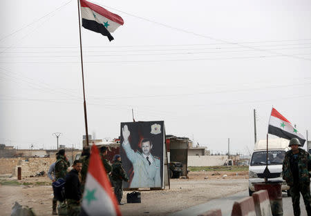 FILE PHOTO: Syrian forces loyal to President Bashar al-Assad hold a checkpoint in Aleppo, Syria February 10, 2018. REUTERS/Omar Sanadiki/File Photo