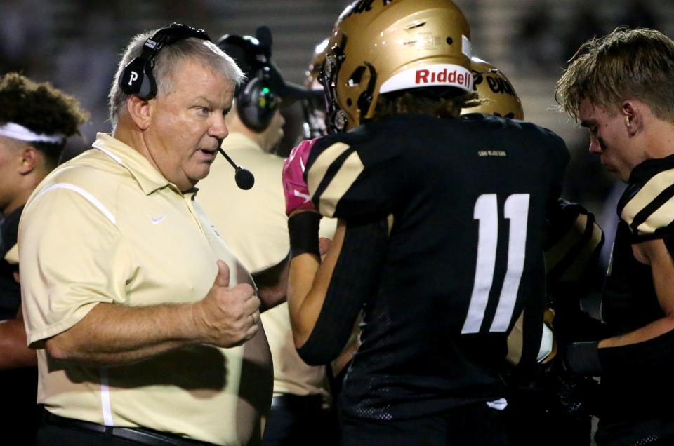 Penn Head Coach Cory Yeoman speaks to Dominic Bonner (11) during the Mishawaka vs. Penn football game Friday, Aug. 25, 2023, at Freed Field. The Kingsmen won over the Cavemen, 28-7.