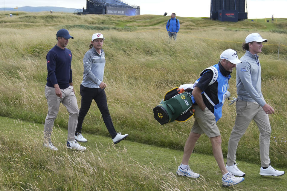 Cameron Smith of Australia and compatriot Adam Scott, left, walk together during a practice round ahead of the British Open Golf Championships at Royal Troon golf club in Troon, Scotland, Tuesday, July 16, 2024. (AP Photo/Jon Super)