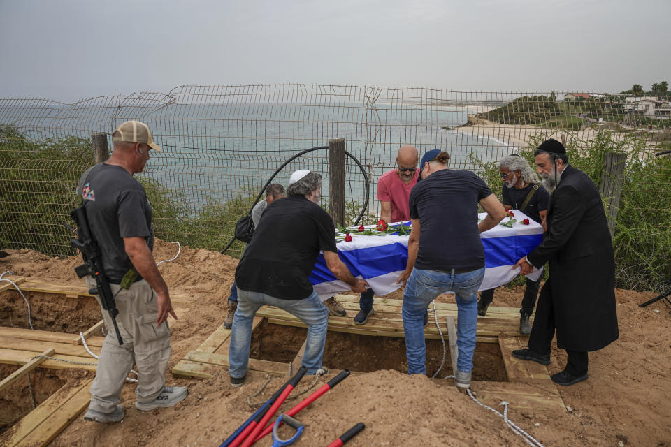 Friends and relatives of Yonat Or carry her coffin during her funeral at Kibbutz Palmachim, Israel, Sunday, Oct. 29, 2023. Or was killed by Hamas militants on Oct. 7, in Kibbutz Be'eri near the border with the Gaza Strip. More than 1,400 people were killed and some 220 captured in an unprecedented, multi-front attack on Israel by the militant group that rules Gaza. (AP Photo/Ariel Schalit)