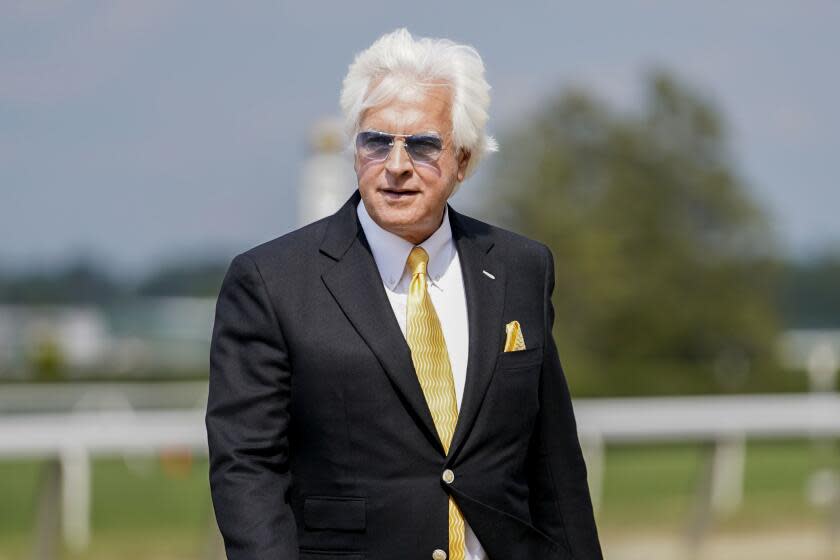 Trainer Bob Baffert walks off the track after his horse Arabian Lion won The Woody Stephens.