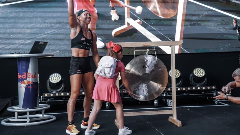 Jacoby crosses the finish line in Nice and is greeted by her nine-year-old daughter. - Hyrox