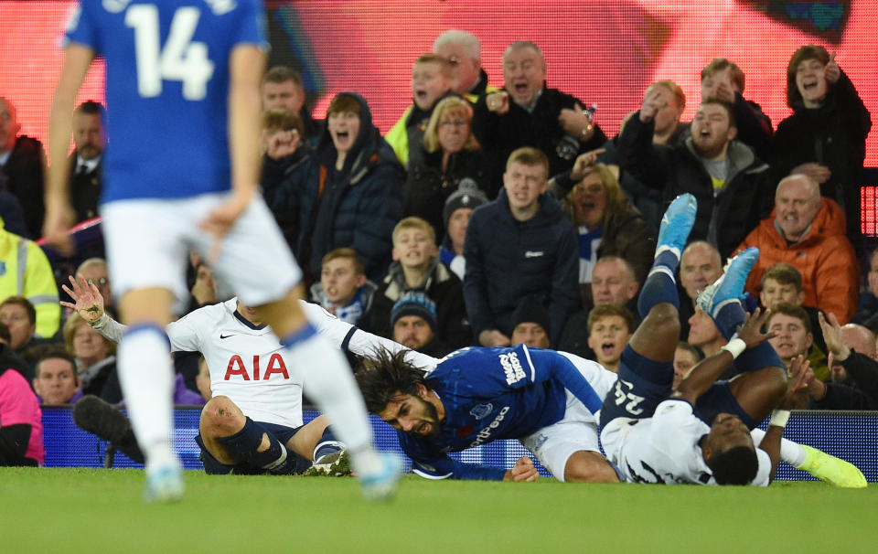 Everton's Portuguese midfielder André Gomes (C) reacts as he gets injured in a challenge with Tottenham Hotspur's South Korean striker Son Heung-Min (L) and Tottenham Hotspur's Ivorian defender Serge Aurier (R) during the English Premier League football match between Everton and Tottenham Hotspur at Goodison Park in Liverpool, north west England on November 3, 2019. (Photo by Oli SCARFF / AFP) / RESTRICTED TO EDITORIAL USE. No use with unauthorized audio, video, data, fixture lists, club/league logos or 'live' services. Online in-match use limited to 120 images. An additional 40 images may be used in extra time. No video emulation. Social media in-match use limited to 120 images. An additional 40 images may be used in extra time. No use in betting publications, games or single club/league/player publications. /  (Photo by OLI SCARFF/AFP via Getty Images)