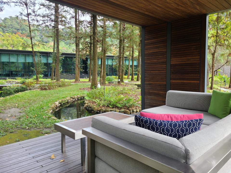 Inside a wooden gazebo on the resort property with a couch inside