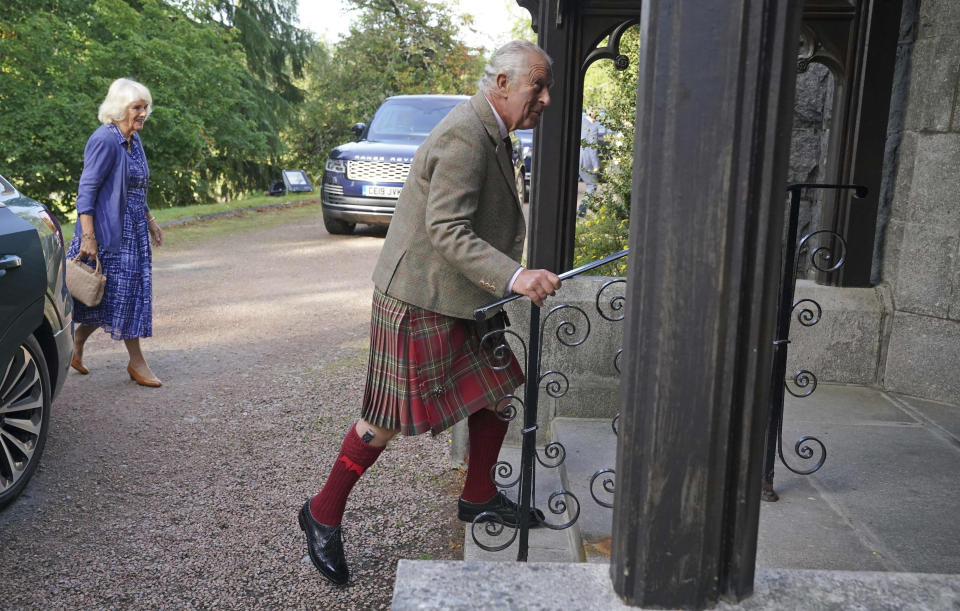 Britain's King Charles III, and Queen Camilla, background left, arrive at Crathie Parish Church for a church service to mark the first anniversary of the death of Queen Elizabeth II, near Balmoral, Scotland, Friday, Sept. 8, 2023. (Andrew Milligan/Pool Photo via AP)