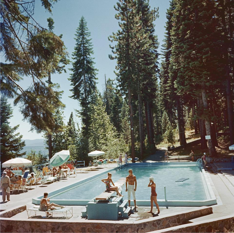 Sunbathers by a pool surrounded by trees at Lake Tahoe in 1959