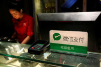 A notice accepting WeChat Pay is displayed at the cashier inside a restaurant in Guangzhou, China May 9, 2017. Picture taken May 9, 2017. REUTERS/Bobby Yip