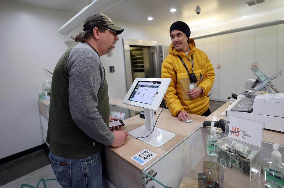 Robert Stosich talks with Dragonfly Wellness fulfillment manager Dio Bone about his options as he purchases medical cannabis for the first time at Dragonfly Wellness in Salt Lake City on Thursday, April 20, 2023. Stosich hopes to use medical cannabis for anxiety and bipolar disorder. | Kristin Murphy, Deseret News