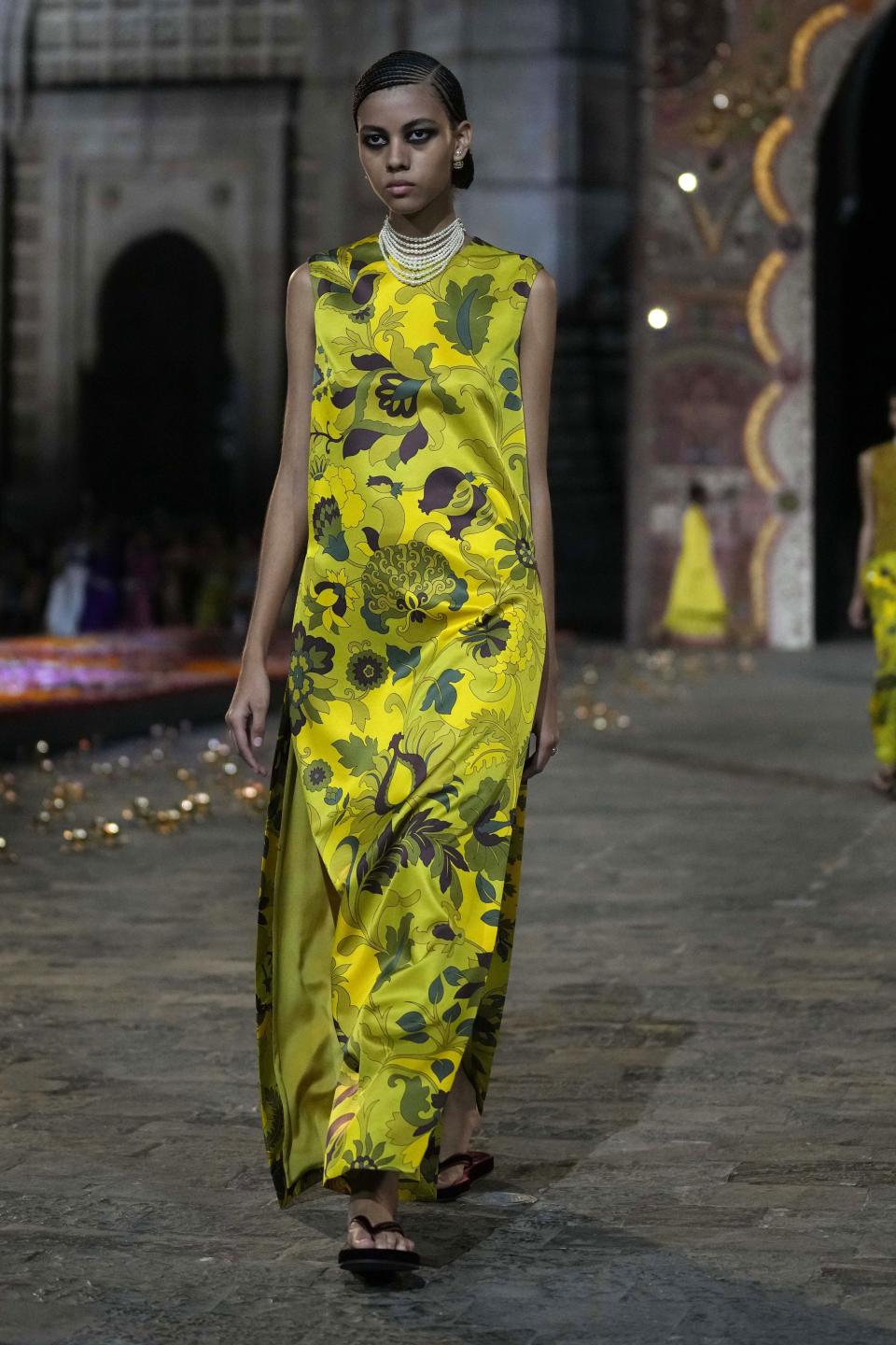 A model wears a creation for the Dior Pre-Fall 2023 collection at the Gateway of India landmark monument in Mumbai, India, Thursday, March 30, 2023. (AP Photo/Rafiq Maqbool)