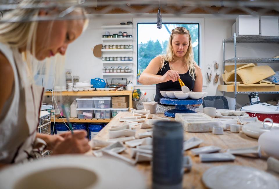 Ceramic artist Claire Thibodeau, right, of Thibodeau Ceramic Design and Mottoform founder and designer Elizabeth Salonen work on their line of ceramics at Thibodeau's home studio in Ferndale on Thursday, September 7, 2023. The duo partnered with the West Village restaurant Marrow during Detroit Design Month to host Tablescape, a dinner that merges art and food.