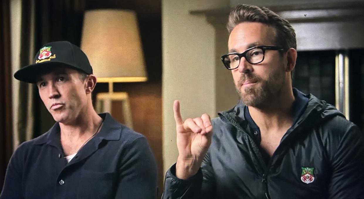 Ryan Reynolds (right) and business partner Rob McElhenney take etiquette lessons prior to meeting the king of England. (FX)