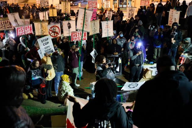 Demonstrators hold signs and listen to speakers during a protest on March 9 over plans to build a new police training center near Atlanta.