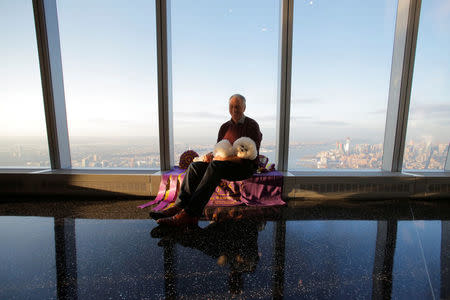 Handler Bill McFadden holds Flynn, a Bichon Frise, at the One World Observatory a day after winning the "Best in Show" at the Westminster Kennel Club Dog Show in Manhattan, New York, U.S., February 14, 2018. REUTERS/Andrew Kelly