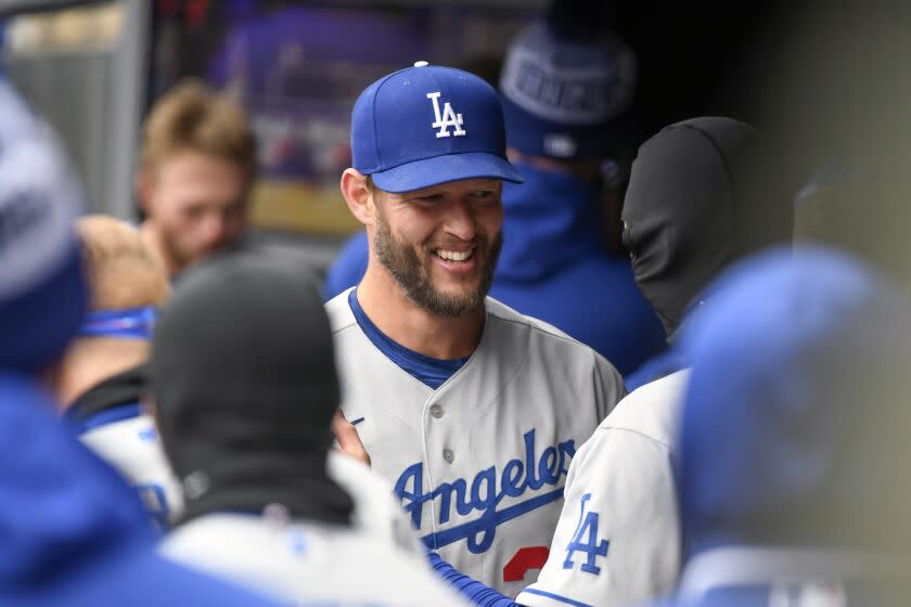 Dodgers pitcher Clayton Kershaw smiles in the dugouts after throwing seven perfect innings against the Minnesota Twins.