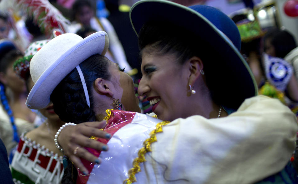 Contestants embrace after they are eliminated in the first round of the Queen of Great Power contest, in La Paz, Bolivia, Friday, May 24, 2019. The largest religious festival in the Andes choses its queen in a tight contest to head the Festival of the Lord Jesus of the Great Power, mobilizing thousands of dancers and more than 4,000 musicians into the streets of La Paz. (AP Photo/Juan Karita)